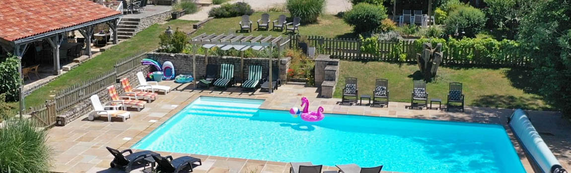Enjoy your holiday lounging around the pool at Maison Lairoux Holiday Cottages